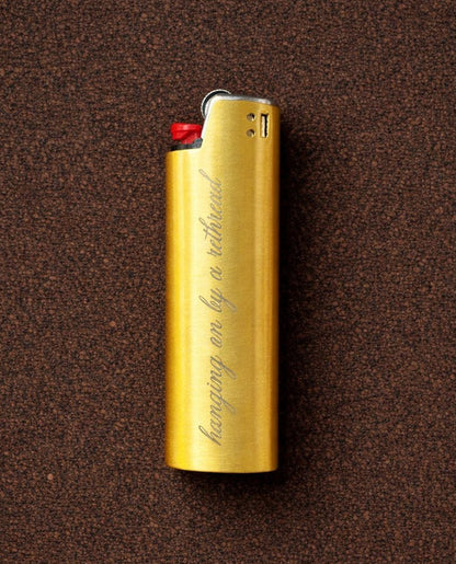 'Hanging on by a Rethread' Lighter Cover - Gold